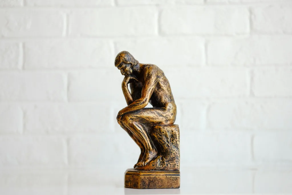 Picture of a statue of the thinking man, pondering .net vs java.