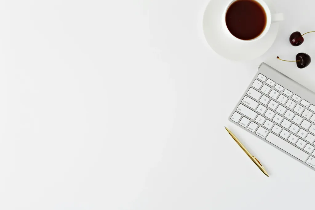 A plain white background with a white keyboard showing the tools of a tech assistant.