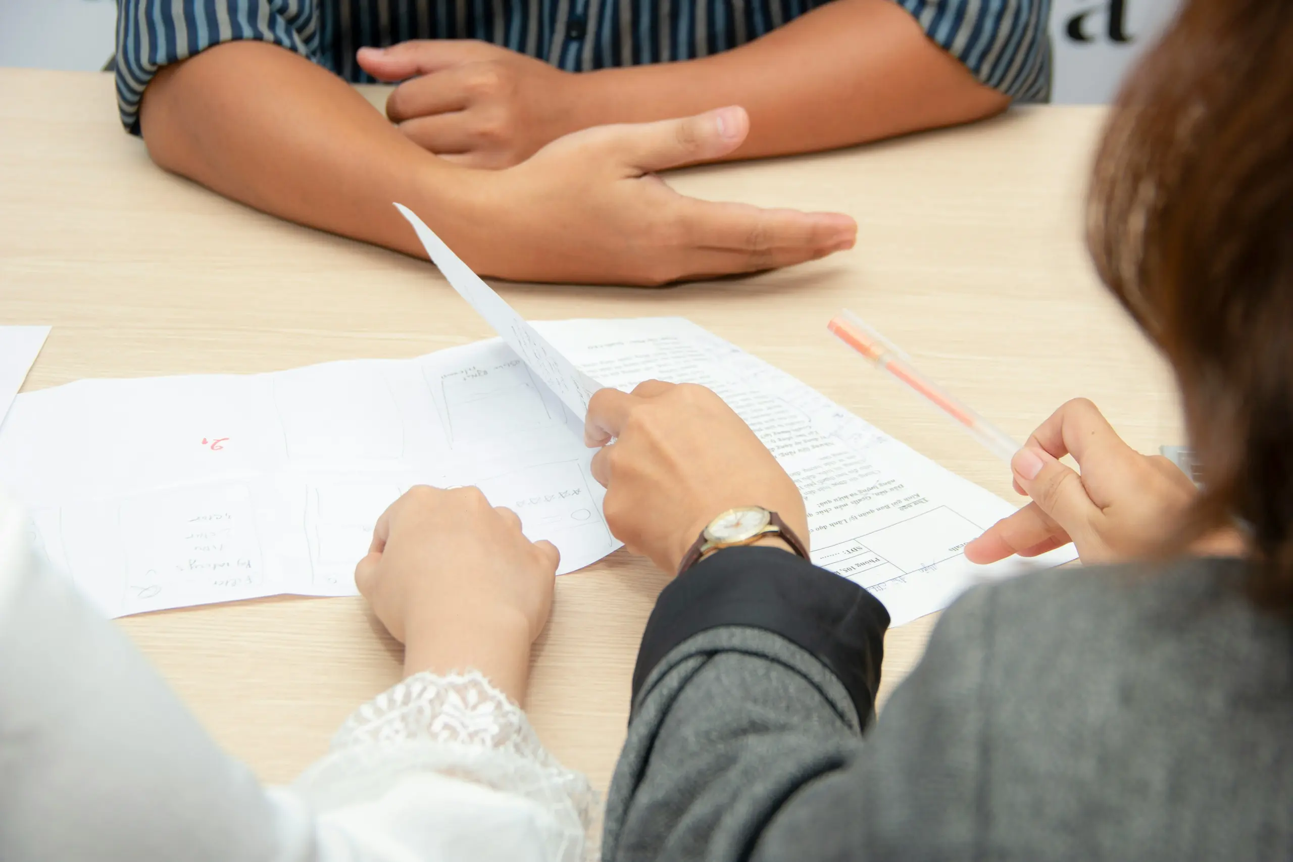 People looking at papers on a table.
