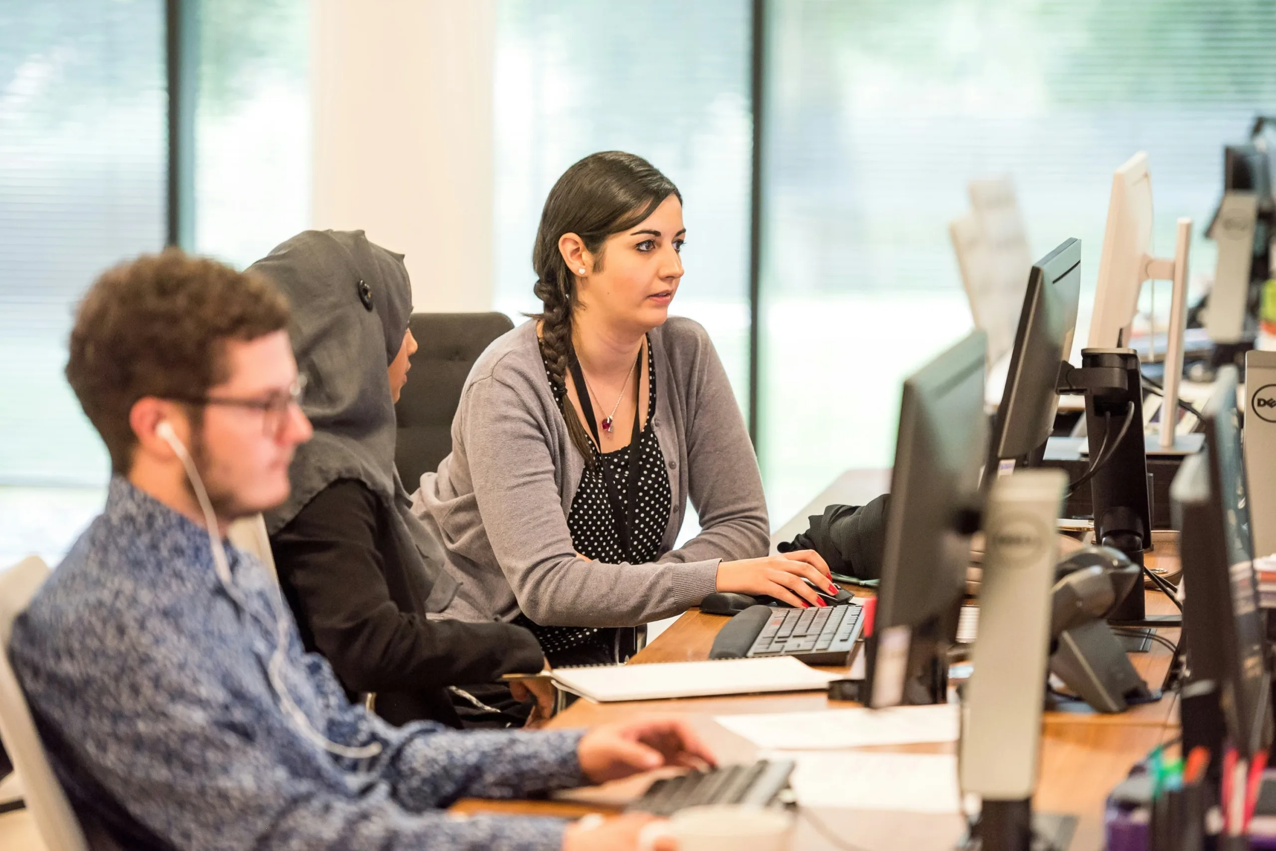 Group of coders working a network security job at a desk.